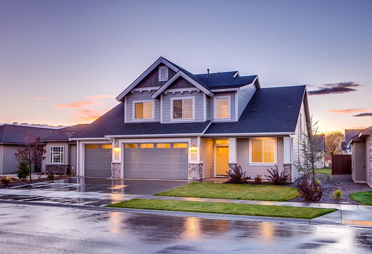 Suburban two-story home with clean wet driveway after a soft wash